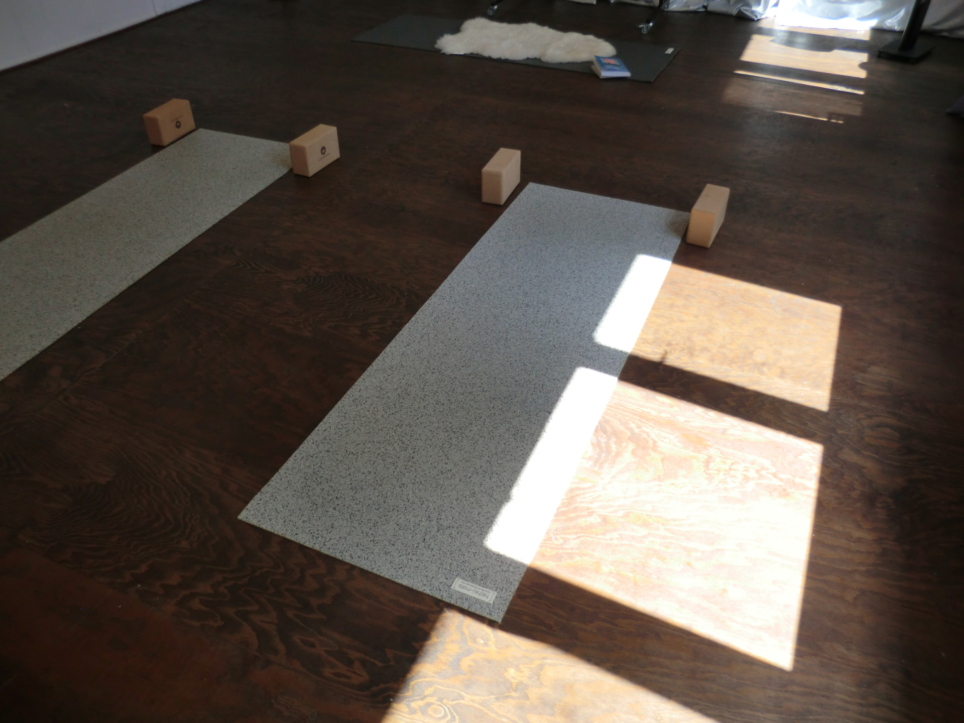 two yoga mats with cork blocks in afternoon light