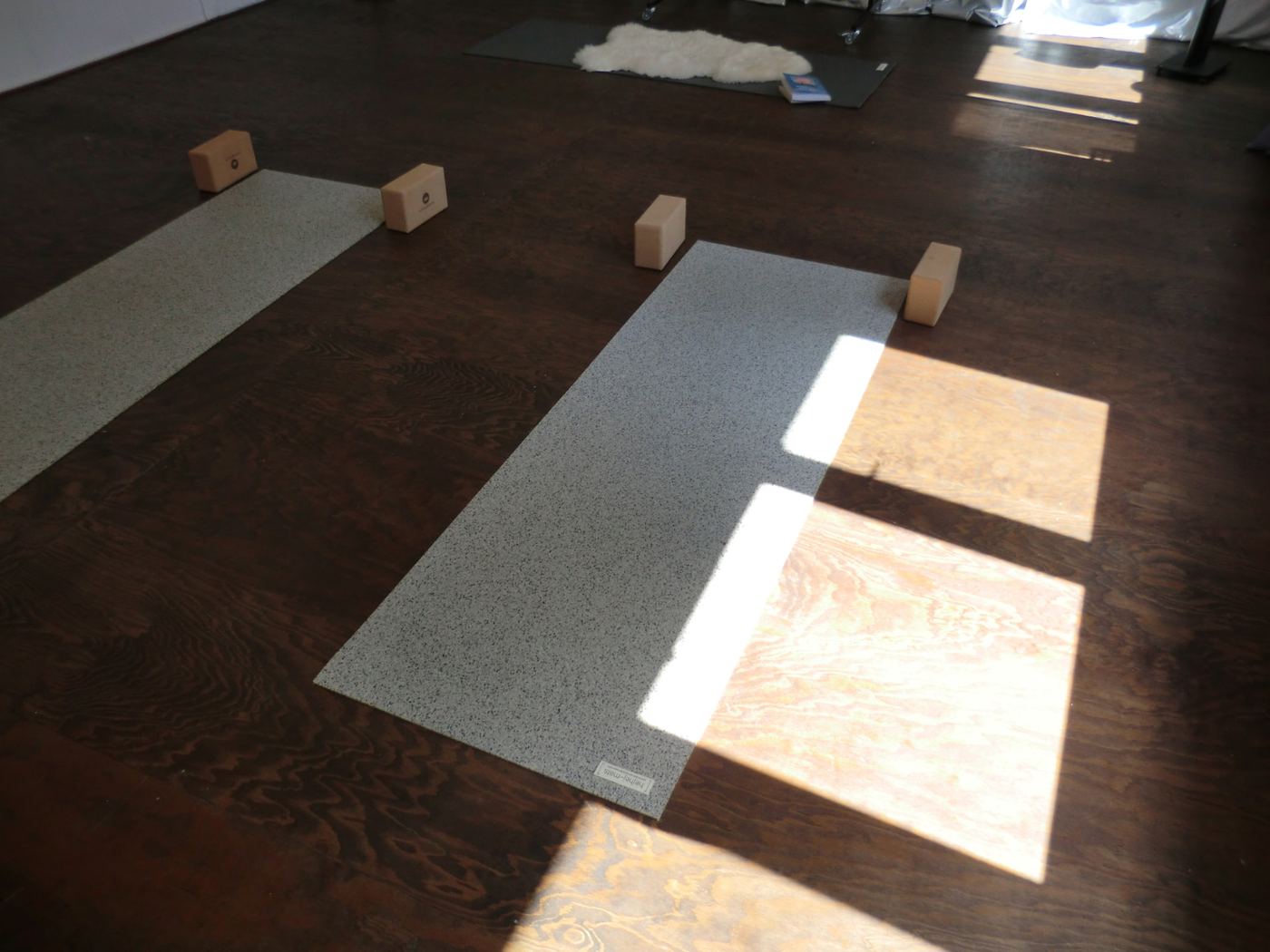 two yoga mats with cork blocks in afternoon light